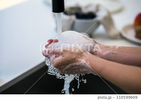 Hands wash procedure, cleaning hands with soap from viruses and contamination. Wash hands before dinner 110599609