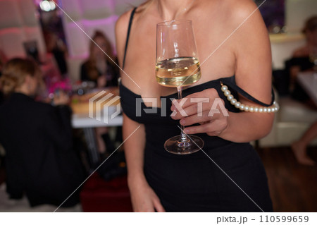 Clinking glasses with alcohol and toasting, party. 110599659