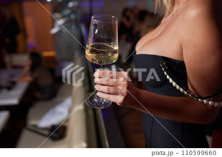 Clinking glasses with alcohol and toasting, party. 110599660