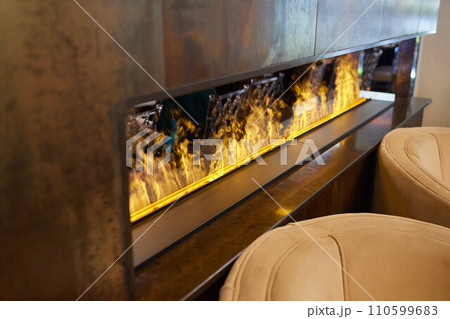 Electric log fireplace. Restaurant showcase decorated with artificial heater. Exterior design. 110599683