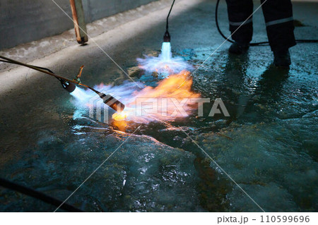 A fiery stream from a kerosene torch to snow and ice A fiery stream from a kerosene torch to snow and ice 110599696