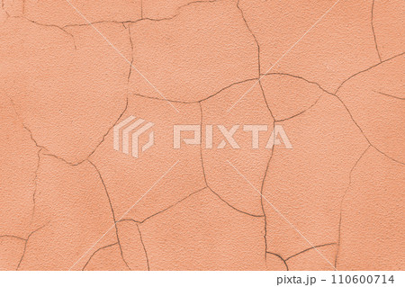 Old stucco plaster surface with cracks, orange plaster wall background Old stucco plaster surface with cracks, orange plaster wall background 110600714