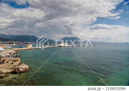 Beautiful sandy beach and soft turqoise Mediterranean sea wave - Landscape of ancient shipyard near of Kizil Kule tower - Alanya peninsula, Turkey 110601096