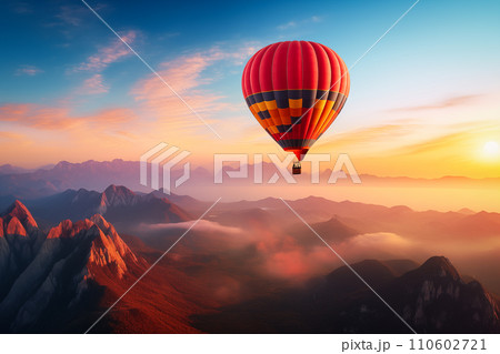 Colorful hot air balloon over desert mountains at sunset Colorful hot air balloon over desert mountains at sunset 110602721