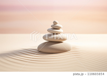 Zen stones stack on raked sand in a minimalist setting for balance and harmony Zen stones stack on raked sand in a minimalist setting for balance and harmony 110603854
