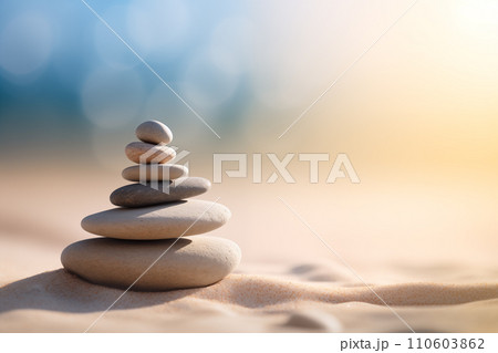 Zen stones stack on sand waves in a minimalist setting for balance and harmony Zen stones stack on sand waves in a minimalist setting for balance and harmony 110603862