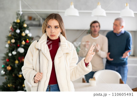 Dissatisfied woman leaves her husband and father during Christmas celebration Dissatisfied woman leaves her husband and father during Christmas celebration 110605491