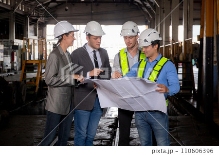 Team young caucasian engineer man and woman in checking train looking blueprint in station. 110606396