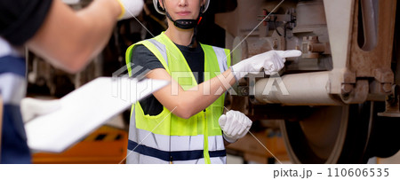 Young caucasian engineer man and woman or worker checking electric train for planning maintenance. 110606535