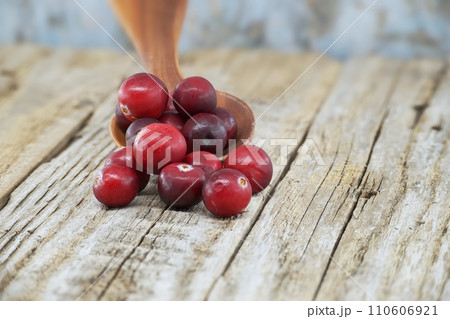 Kitchen scene with fresh cranberries on rustic table 110606921
