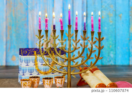 As symbol of Hanukkah in Jewish religion, Hanukkah Menorah is lit with candles As symbol of Hanukkah in Jewish religion, Hanukkah Menorah is lit with candles 110607874
