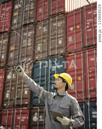 Asian worker wearing safety helmet and using walkie talkie 110608029