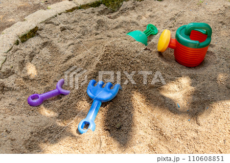 子供用の遊び道具が残された公園の砂場 子供用の遊び道具が残された公園の砂場 110608851