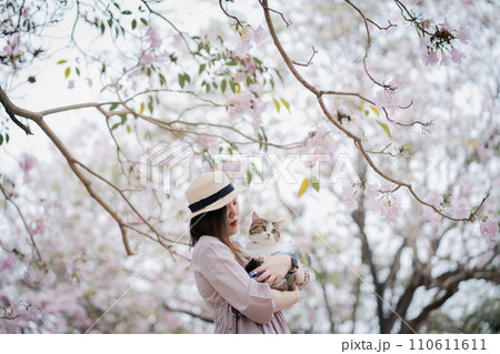 the springtime brings asian woman and her cat on a journey the springtime brings asian woman and her cat on a journey 110611611