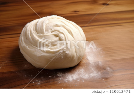 Loaf of fresh bread on floured wooden table. Bread dough before baking. Loaf of fresh bread on floured wooden table. Bread dough before baking. 110612471