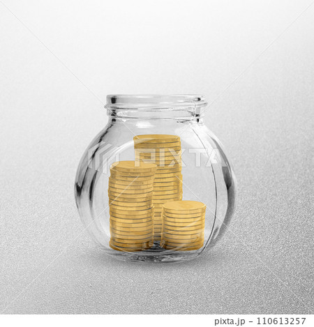 Golden coin stack-filled glass jars 110613257
