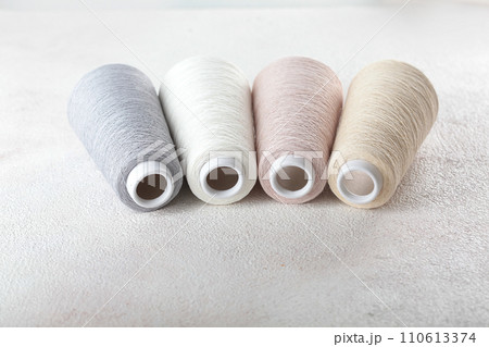 Close-up of yarn balls. Beige, pink and gray. Space for text, banner.Copy space. 110613374