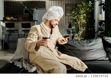 Young relaxed man texting in smartphone Young relaxed man texting in smartphone 110614726