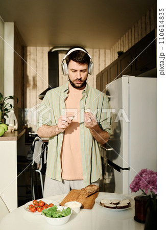 Spreading cheese on slices of bread Spreading cheese on slices of bread 110614835