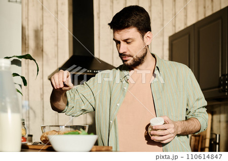 Adding salt into bowl with liaison Adding salt into bowl with liaison 110614847