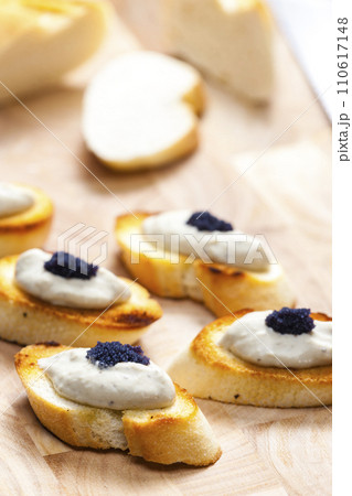anchovy spread on toasted baguette slices 110617148