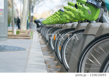 Bicycle for rent, number of wheels is on parking. 110618093