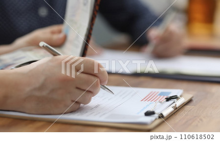 Man filling out documents for US visa closeup 110618502