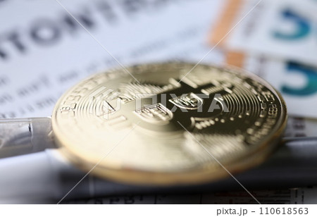 Gold bitcoin lies on table. Making money on bitcoins without investments 110618563