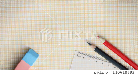 Graph paper with pencils and ruler lie on table 110618993