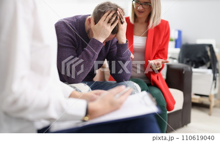 Upset man with woman at psychotherapist appointment Upset man with woman at psychotherapist appointment 110619040