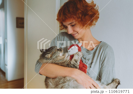portrait domestic cat hugging toy in arms young woman portrait domestic cat hugging toy in arms young woman 110619771