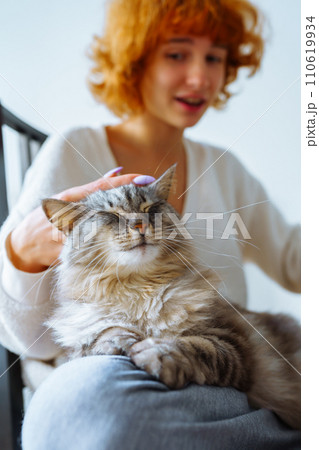 portrait red-haired attractive young woman with fluffy domestic cat 110619934