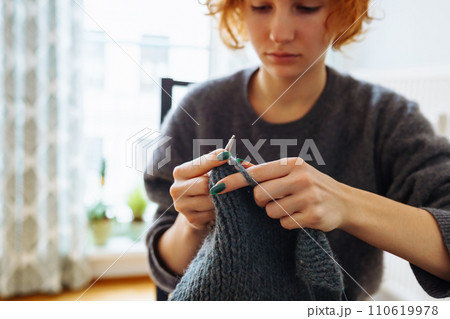 young woman knits wool product young woman knits wool product 110619978