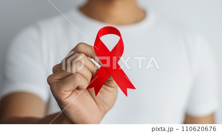 エイズ予防を訴えるレッドリボンを持った男性：AI作品 110620676