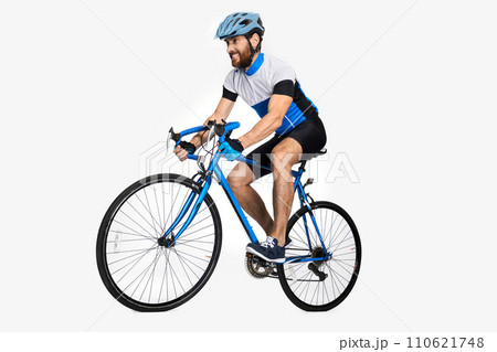 Bearded caucasian cyclist wearing sports equipment, riding bike. Side view of male cyclist making effort to ride fast, isolated on white studio background. Concept of sport lifestyle, action, motion. 110621748