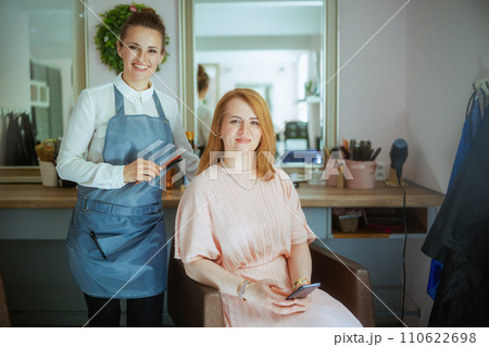 female hairdresser in modern hair studio with hairbrush female hairdresser in modern hair studio with hairbrush 110622698