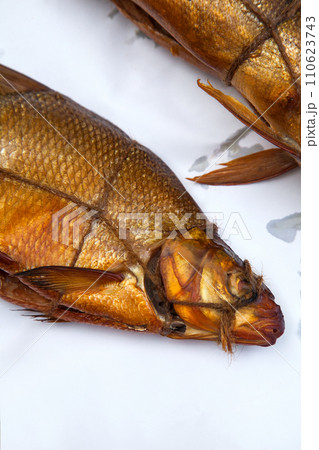 Smoked freshwater common bream fish for home use on white paper.. Smoked freshwater common bream fish for home use on white paper.. 110623743