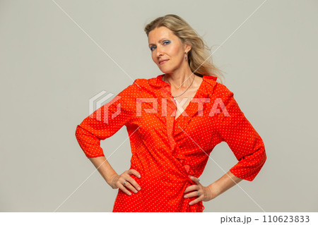 Beautiful grey-haired 50s woman looking at camera isolated on white. Beautiful grey-haired 50s woman looking at camera isolated on white. 110623833