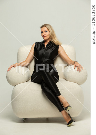 Beautiful grey-haired 50s woman looking at camera isolated on white.  110623850