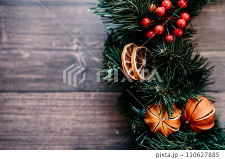 Banner with dried tangerines. Wooden background. Creating unique and eye-catching New Year decor festive atmosphere. Banner with dried tangerines. Wooden background. Creating unique and eye-catching New Year decor festive atmosphere. 110627885