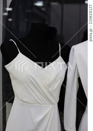 Part of a white classic dress on a black mannequin for sale. 110628127