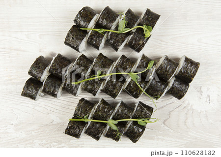 Set of various sushi rolls on a white wooden background close-up. 110628182