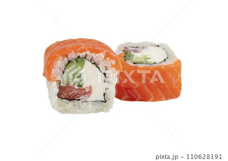 Sushi closeup isolated on white background. Sushi roll baked with red fish, trout, Philadelphia cheese and cucumber and tuna. Japanese restaurant menu. 110628191