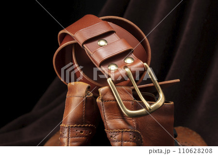 Part of a brown belt made of genuine expensive leather. Part of a brown belt made of genuine expensive leather. 110628208