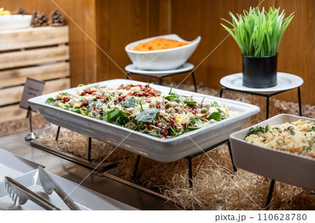 Catering meals prepared for guests at a wedding or hotel dinner. Healthy salads and other vegetables 110628780