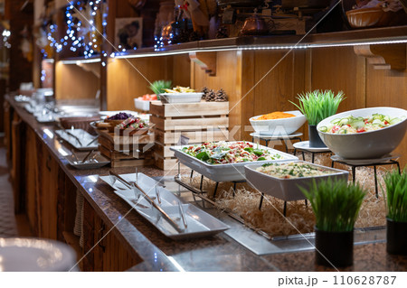 Buffet table full of dishes and salads ready for dinner for hotel guests 110628787