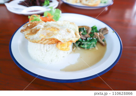 stir fried kale with pork and rice, sunny side up egg stir fried kale with pork and rice, sunny side up egg 110628866