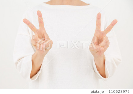 ダブルピースサインをするミドル女性 110628973