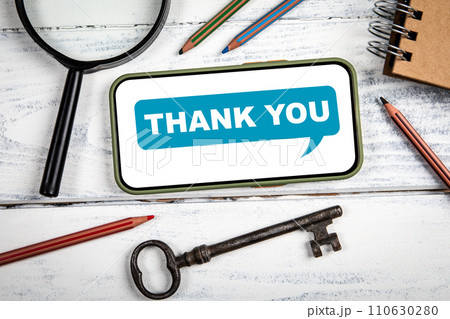 THANK YOU Concept. Mobile phone on white office table THANK YOU Concept. Mobile phone on white office table 110630280