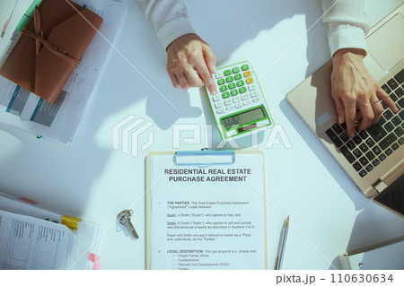 stylish woman real estate agent in green office working 110630634